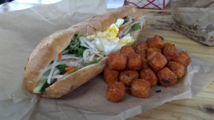Tofu banh mi with pâté and egg, and side of sweet potato tater tots.