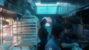 Monica in the foreground, Quynh in the background- overseeing dinner service.